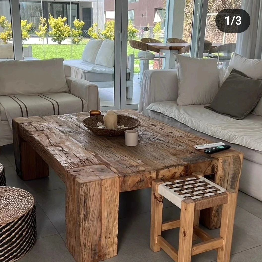 A rustic-styled living room featuring a natural edge wooden coffee table