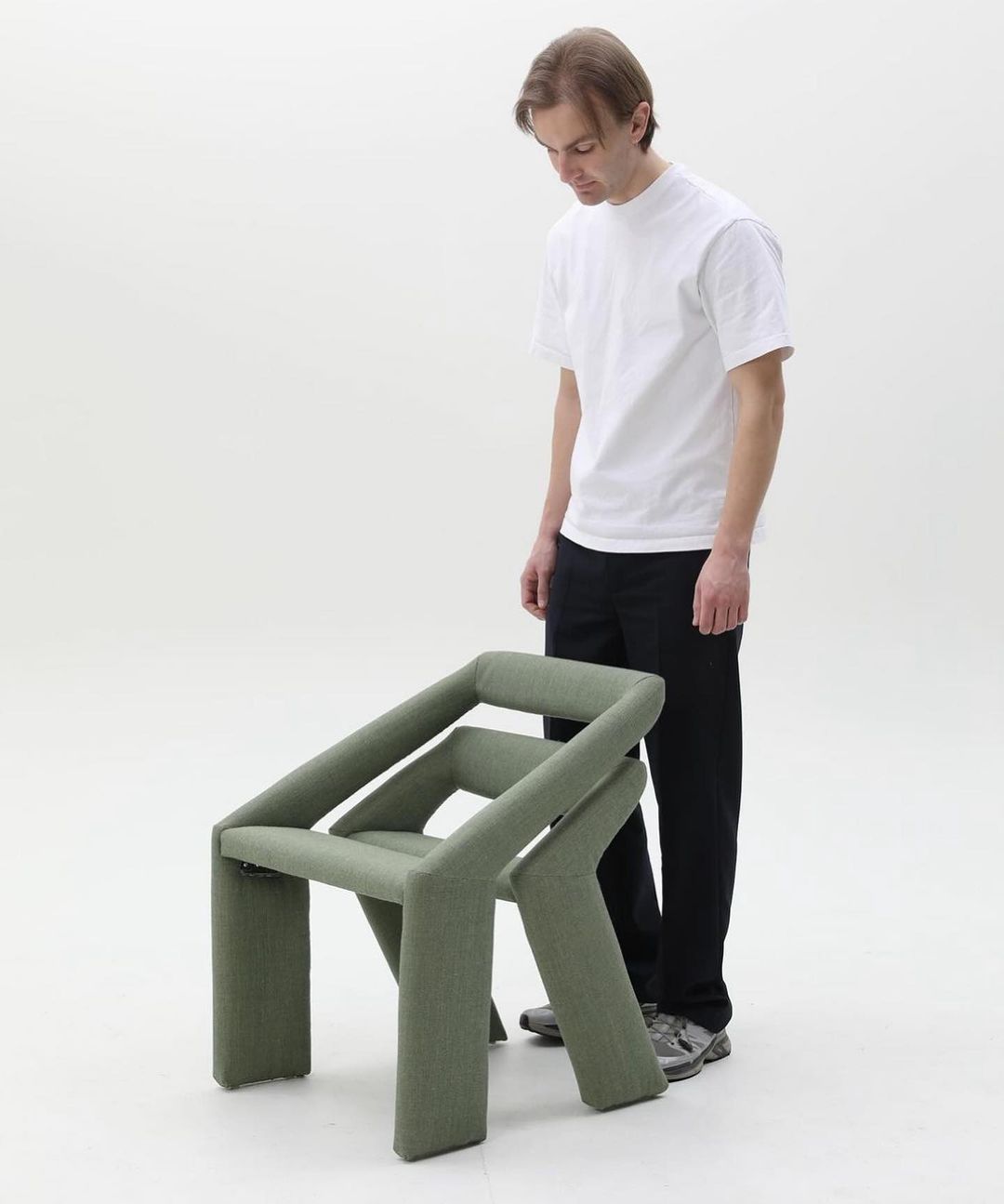 Man observing an unconventional chair