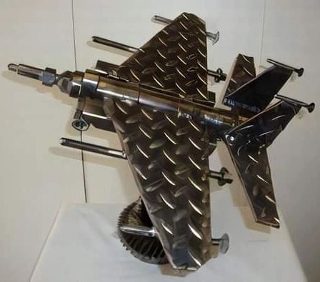 A creative representation of a fighter jet made from various metal parts