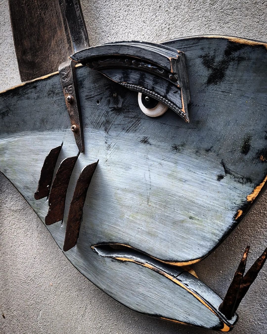 A striking piece of metalwork art showcasing the eye of a fish