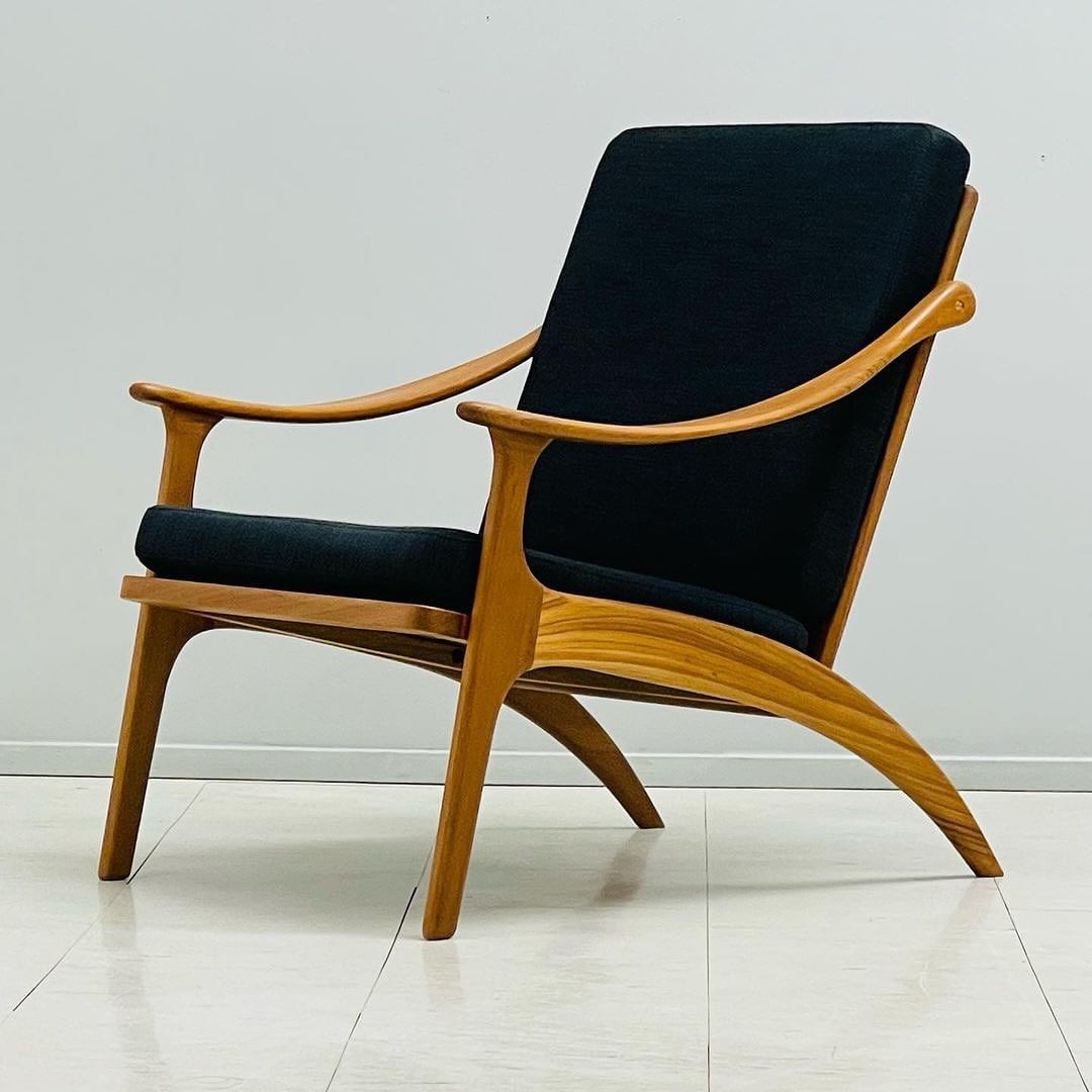 Mid-century modern wooden chair with navy blue cushions