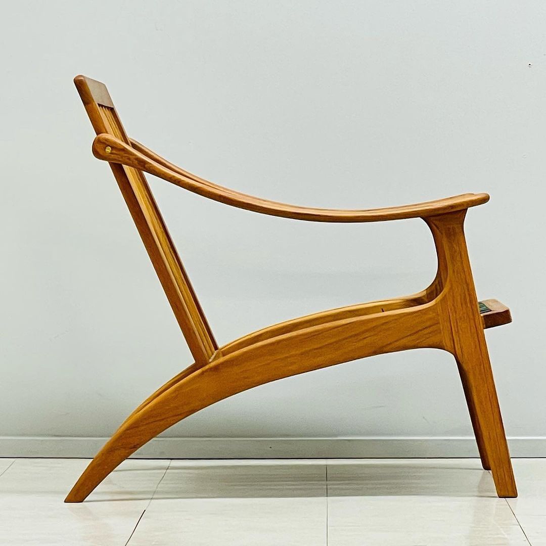 A sculptural wooden chair with fluid lines and organic form