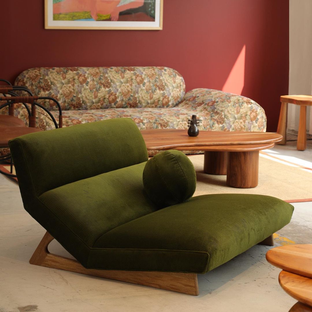 A comfortable and inviting mid-century modern room with a vibrant green chaise lounge