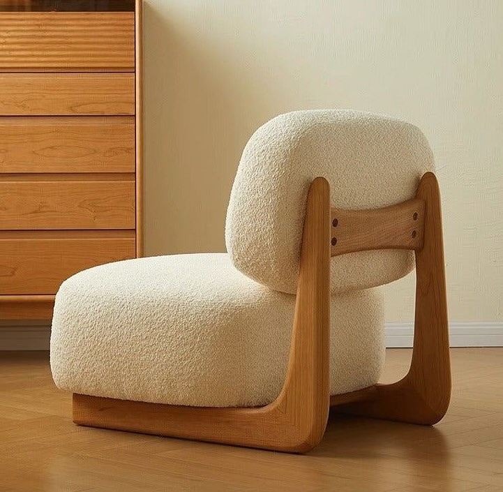 A modern and cozy minimalist chair with plush shearling upholstery and smooth wooden frame