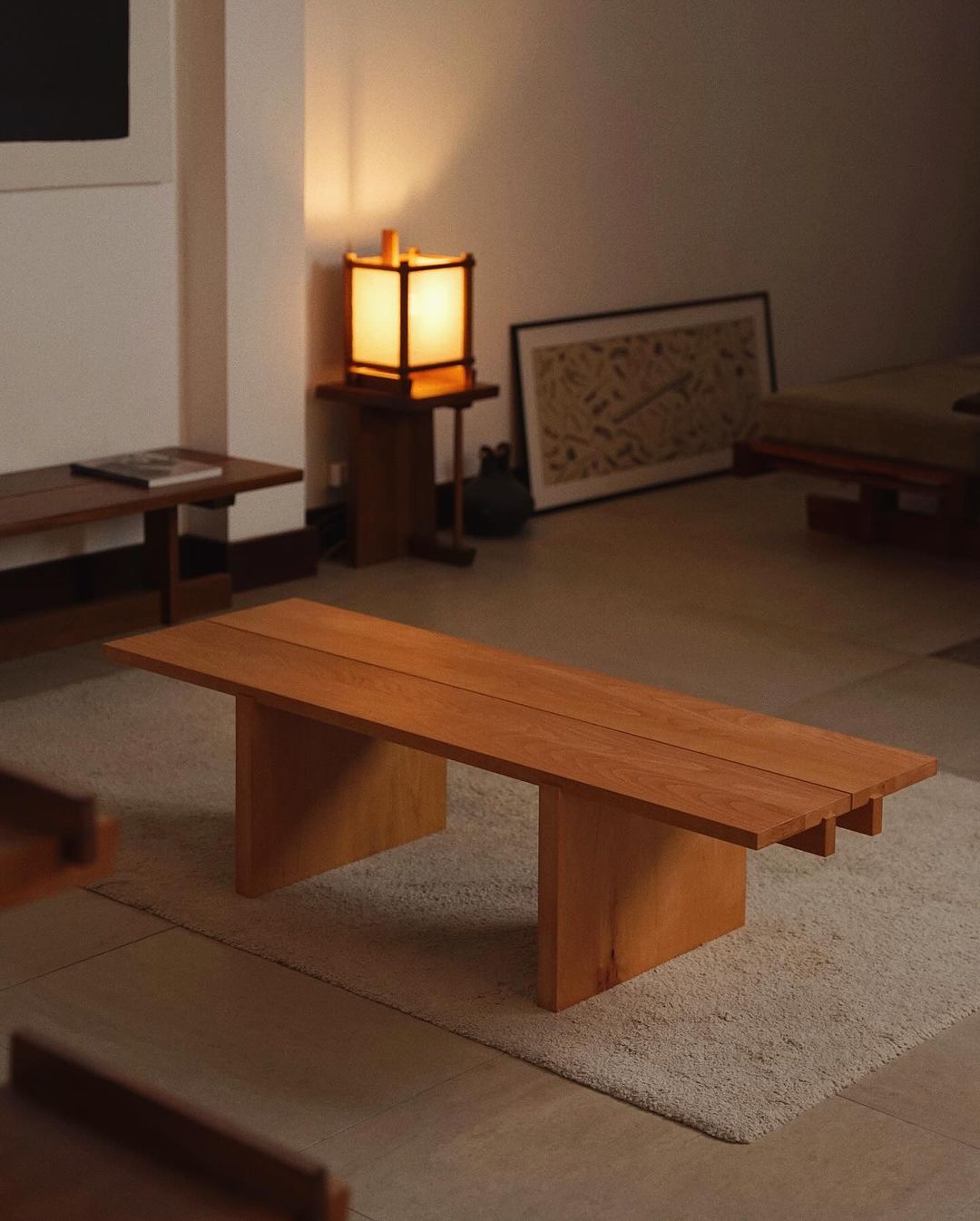 A minimalist Japanese-inspired living room featuring a low wooden table