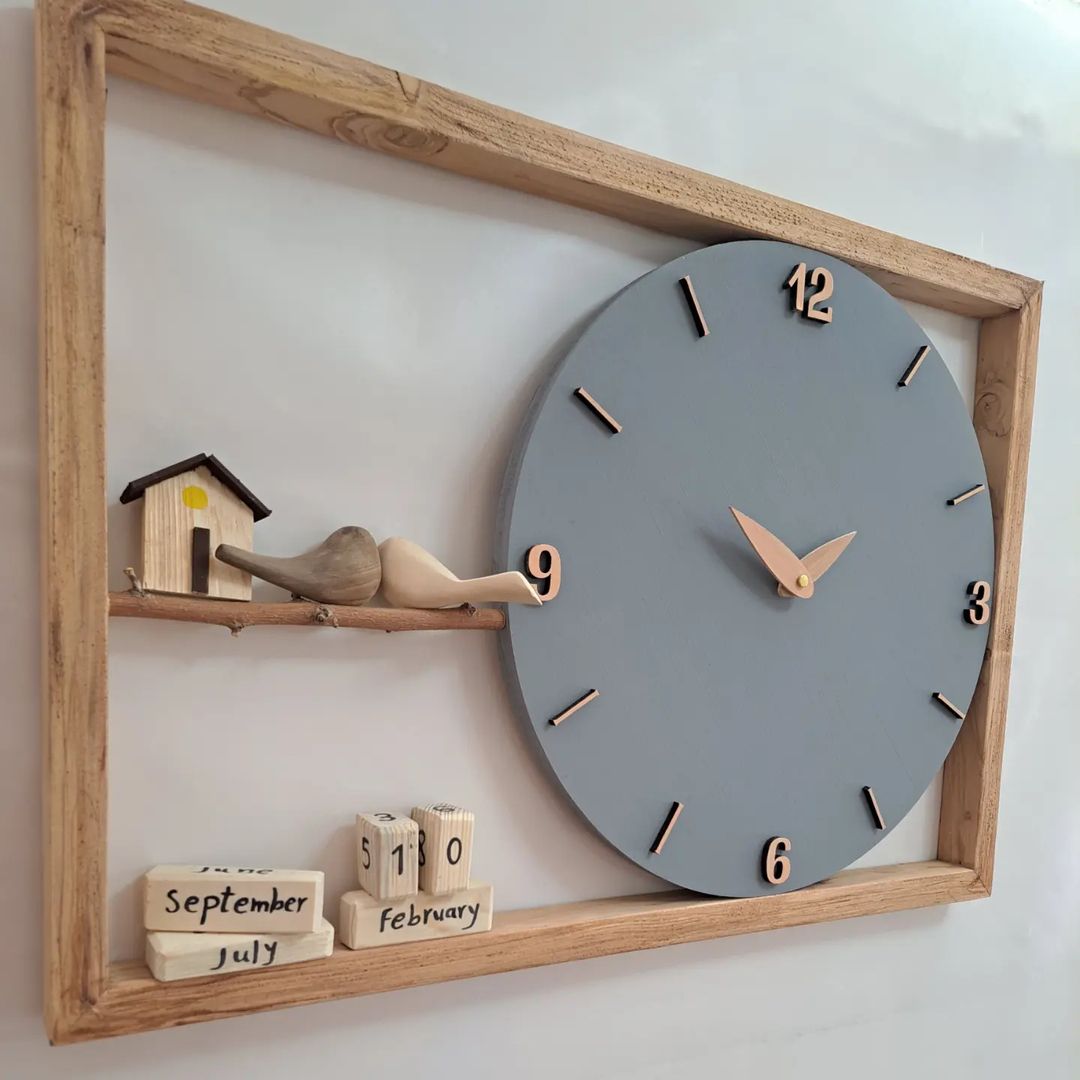 A minimalist wooden wall clock with a grey face and natural elements