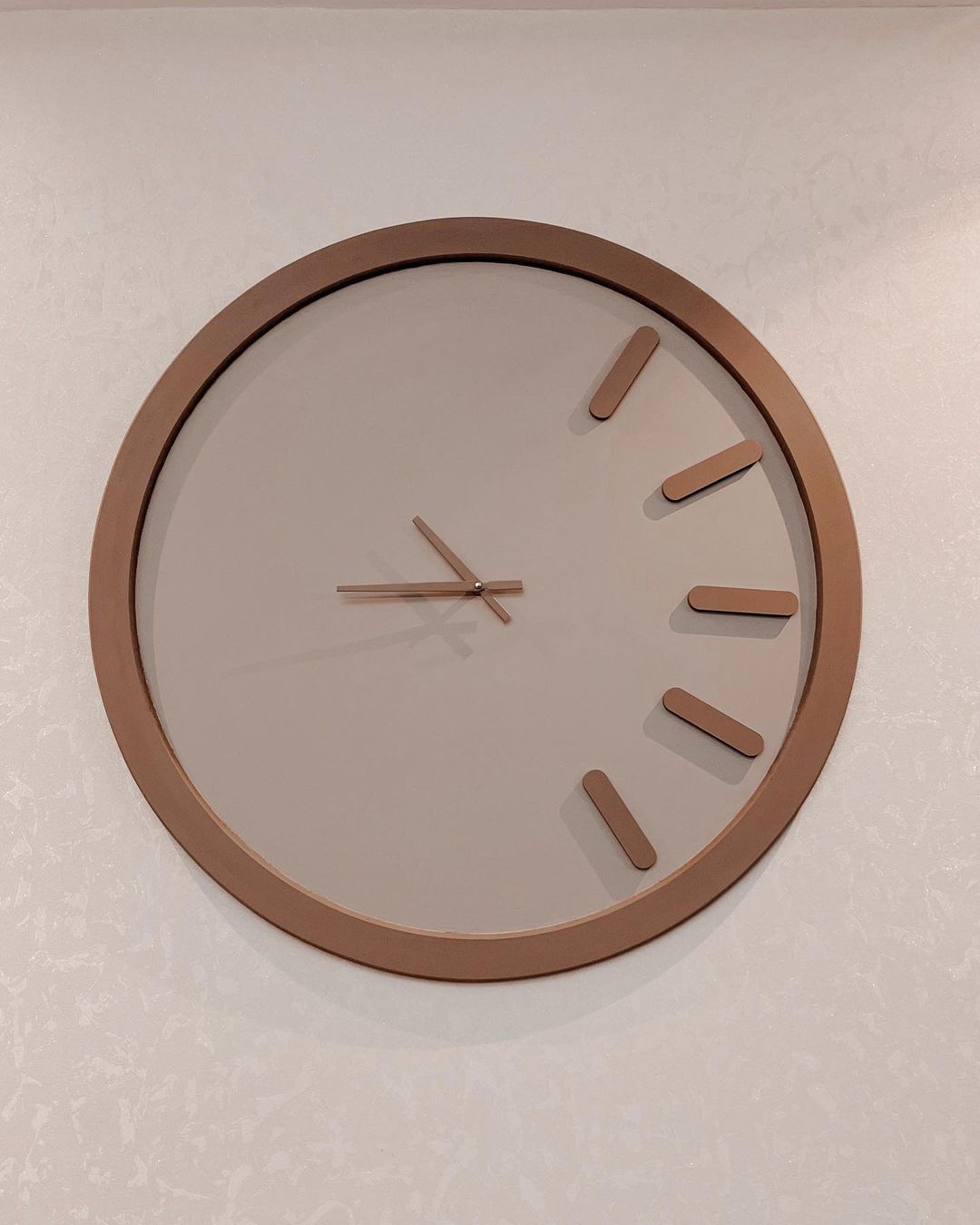 Minimalist wall clock with a brown frame