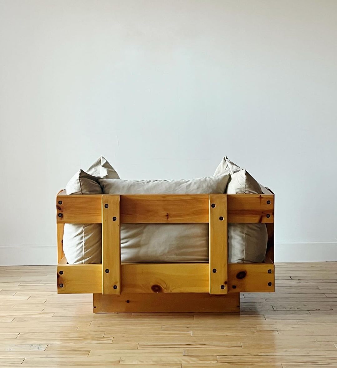 A minimalist wooden bed frame featuring a sturdy construction with visible joinery