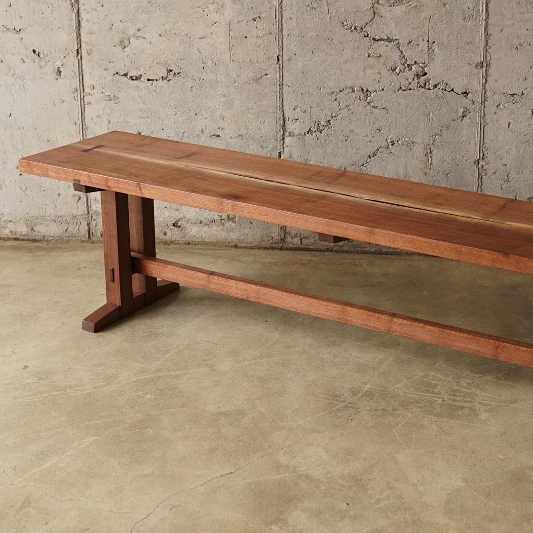 A minimalist wooden bench designed for both functionality and aesthetic appeal