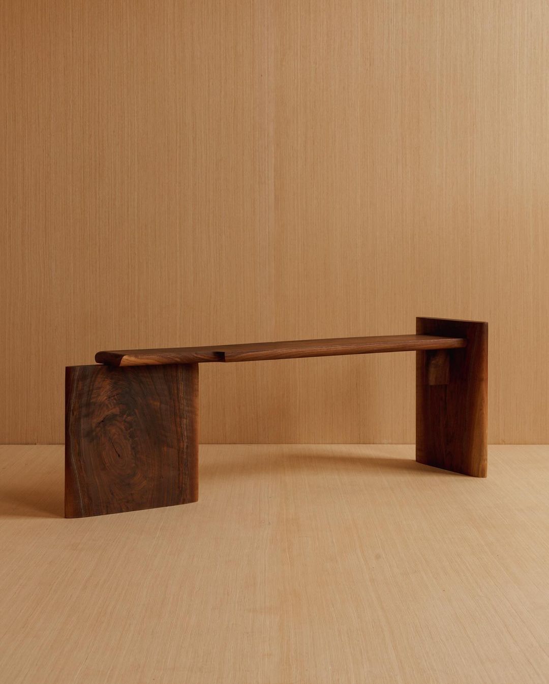 A minimalist wooden bench showcasing bold geometric design