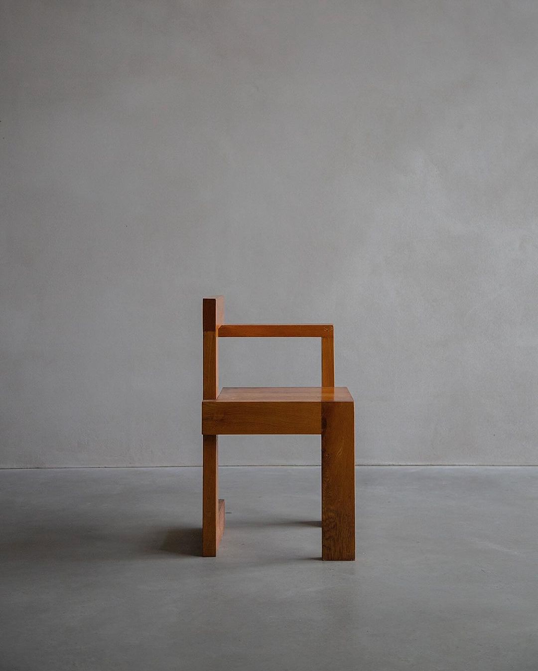 A minimalist wooden chair on a plain background