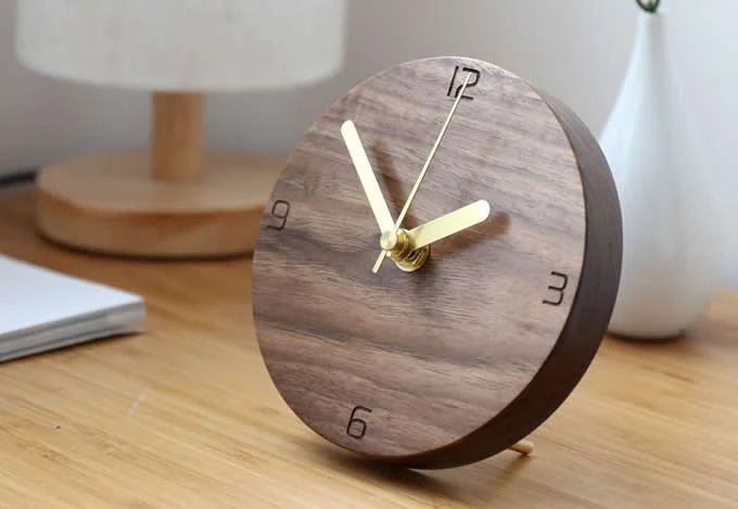 A minimalist wooden desk clock with a simple, modern design