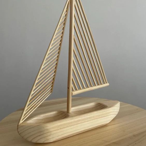 A wooden sailboat model with minimalist design