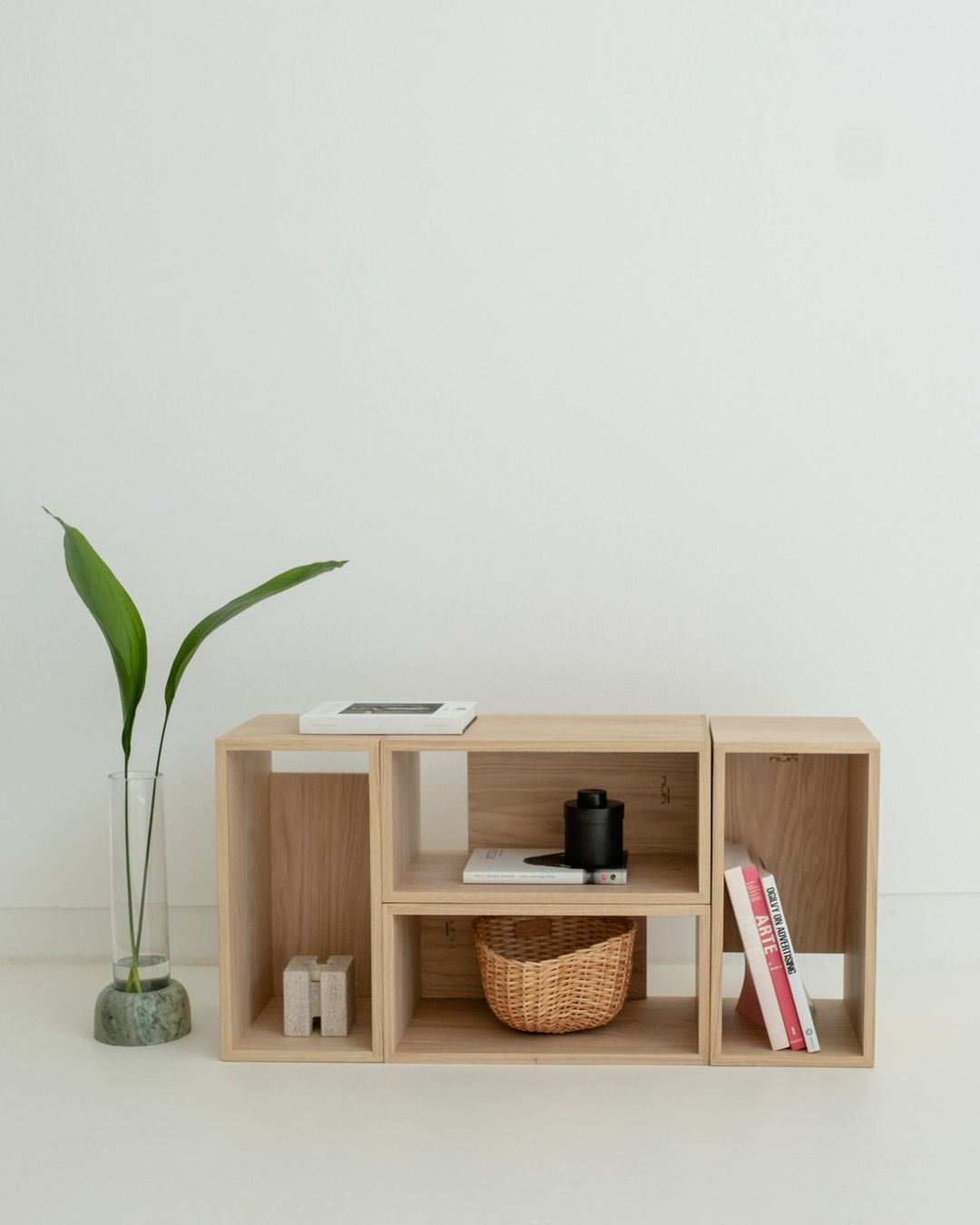 A minimalist wooden shelving unit with a tasteful arrangement of decor