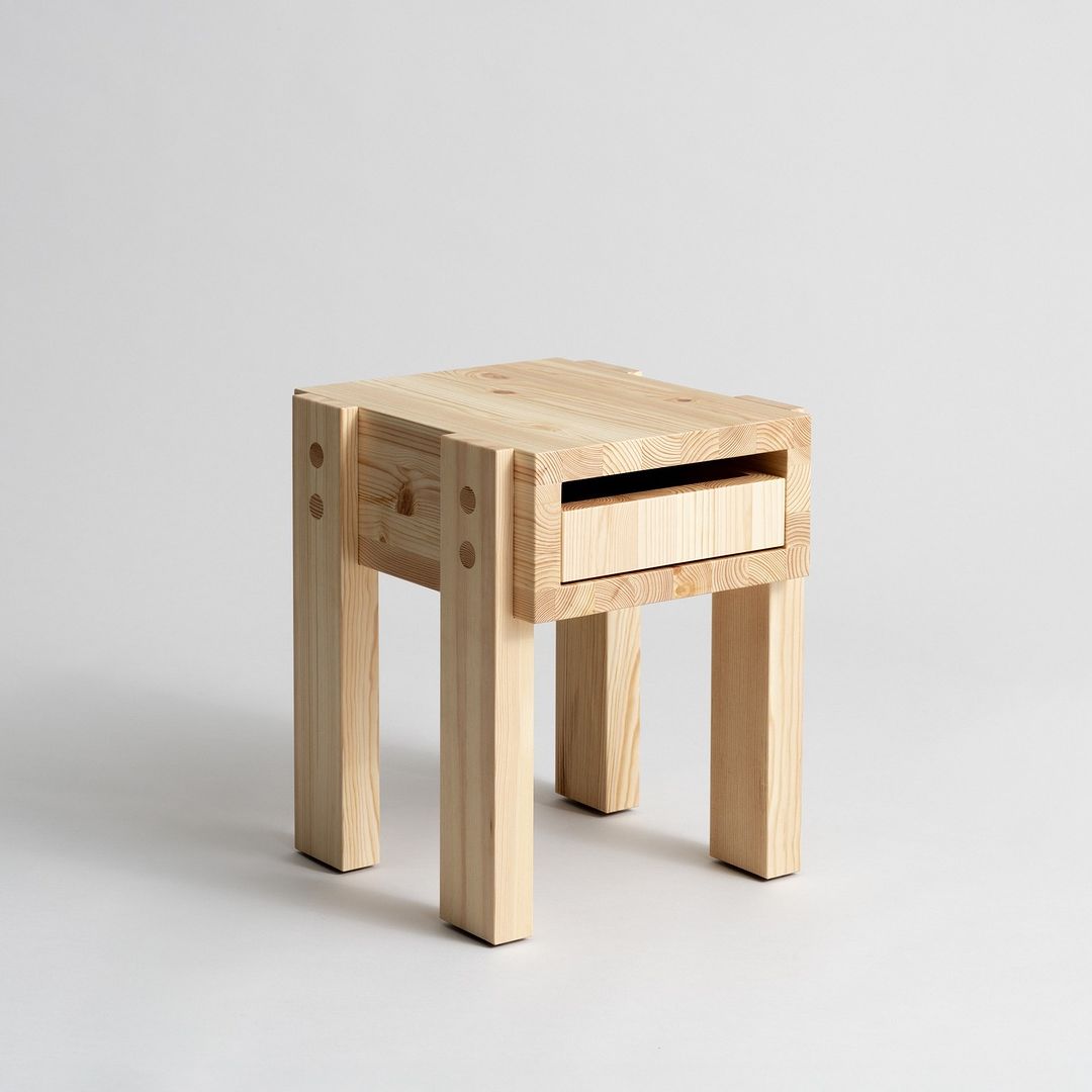 A minimalist wooden stool with an integrated drawer for storage