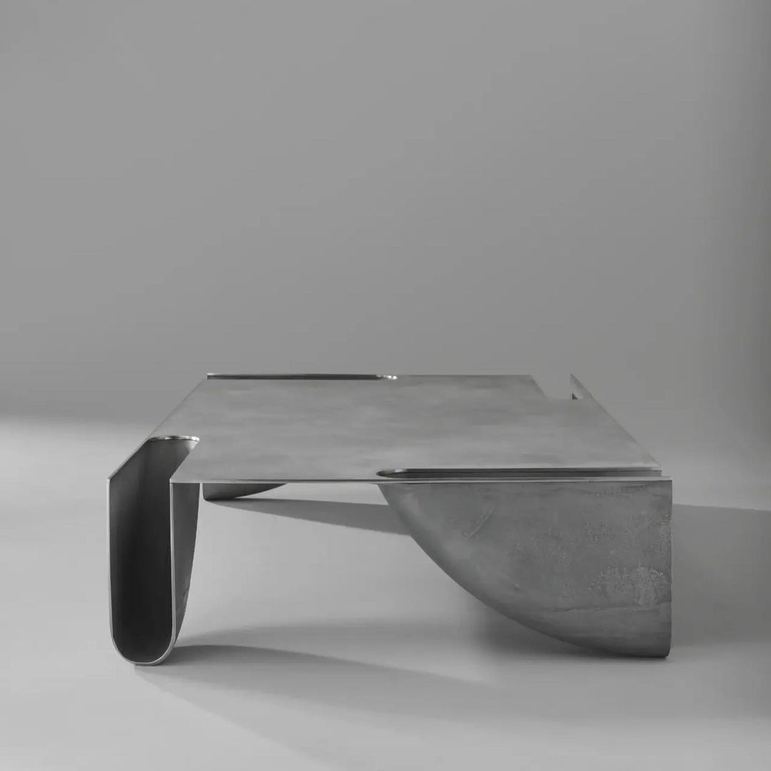 A sleek, contemporary metallic table with a minimalist design