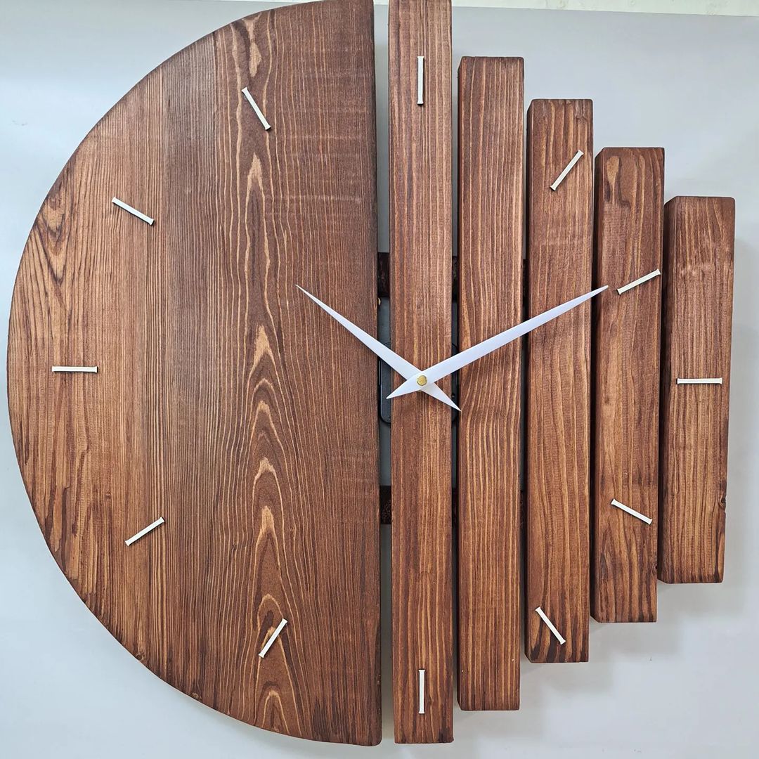 A unique wall-mounted clock featuring separated wooden slats as hour markers.