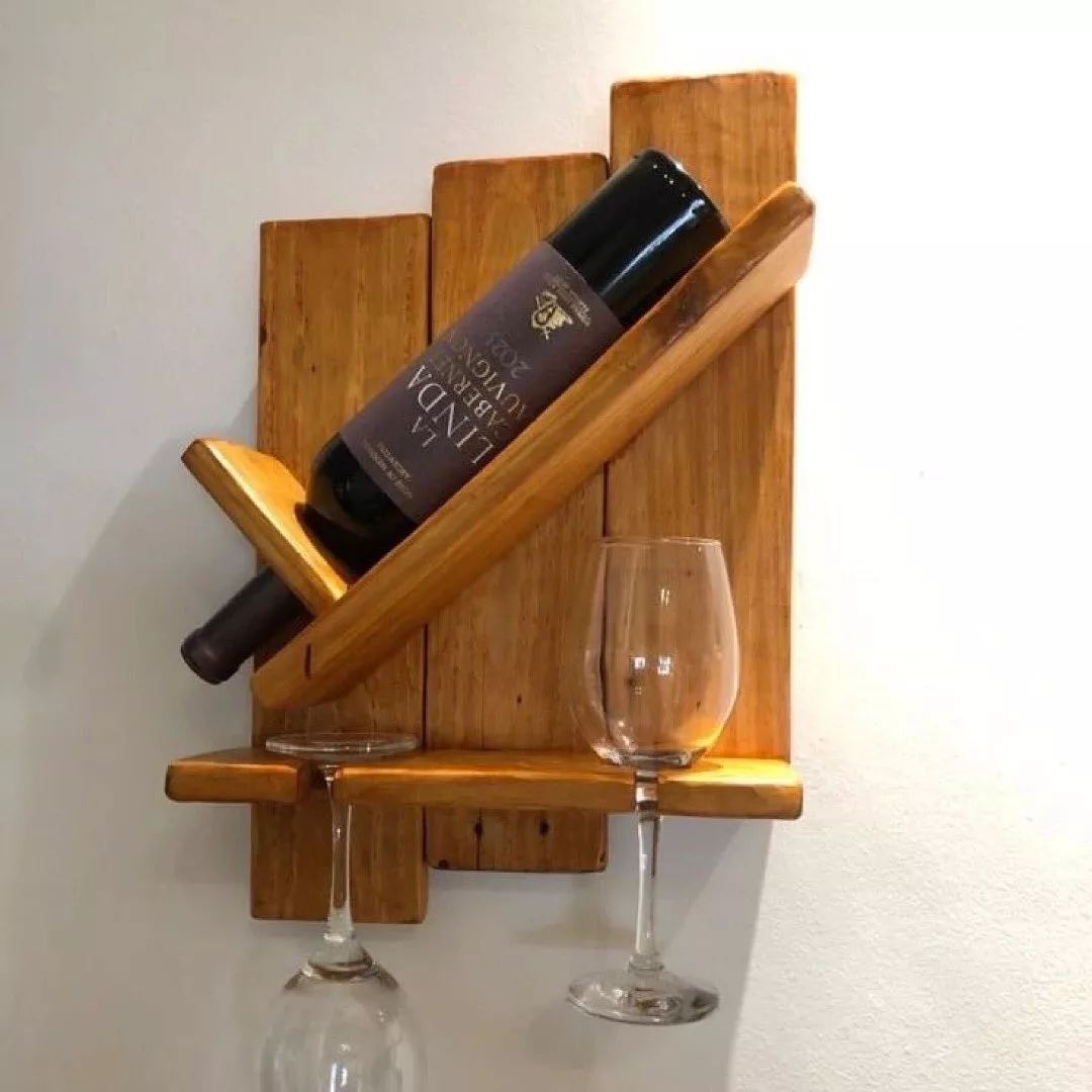 Balanced wine bottle and glasses on wooden rack