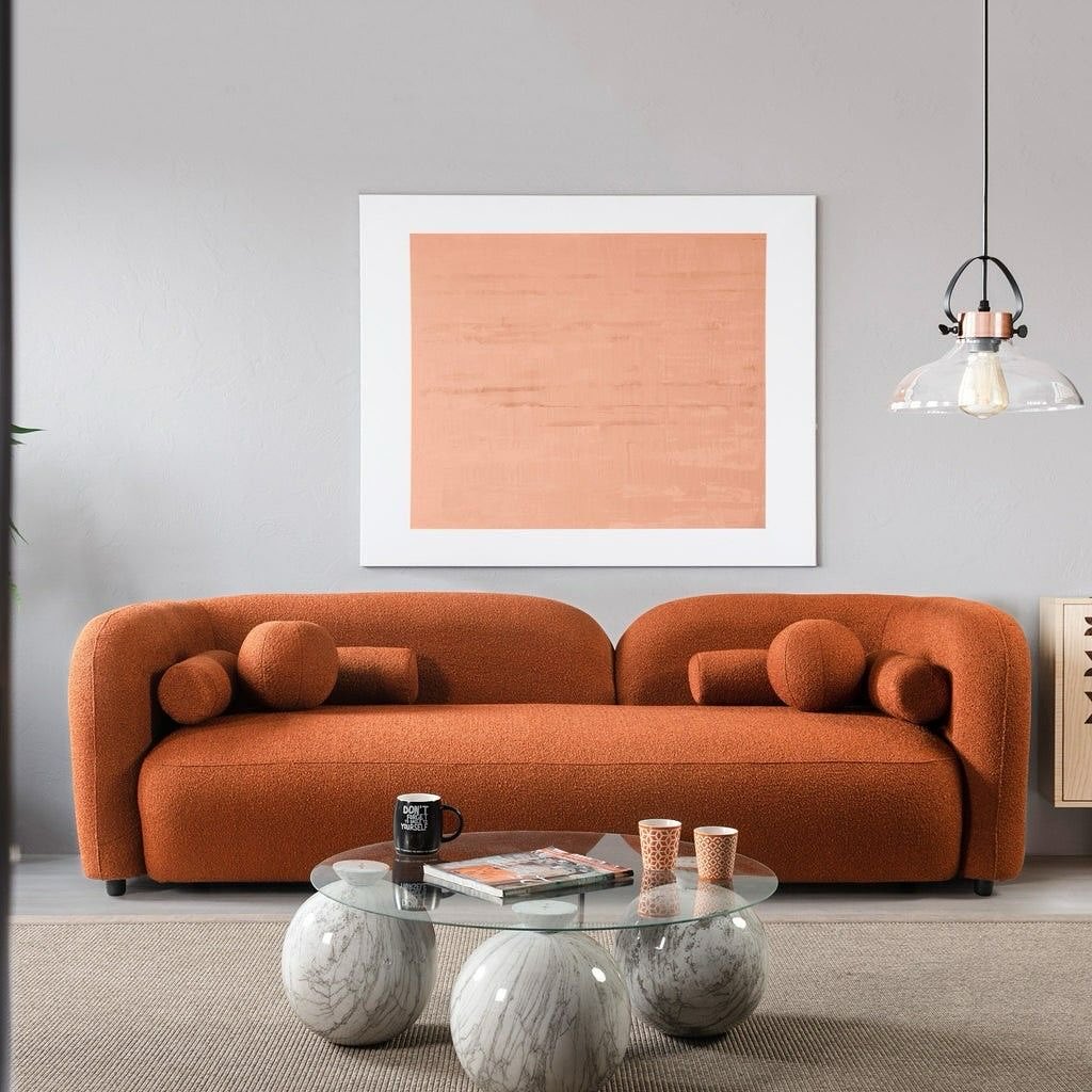 A cozy modern living room scene with a stylish orange sofa