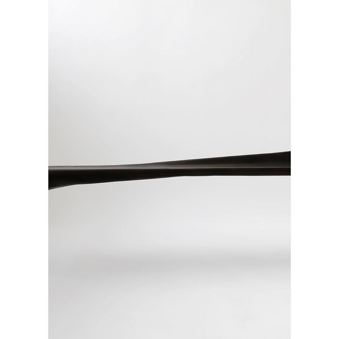 A minimalist modern shelf with a sleek curve design