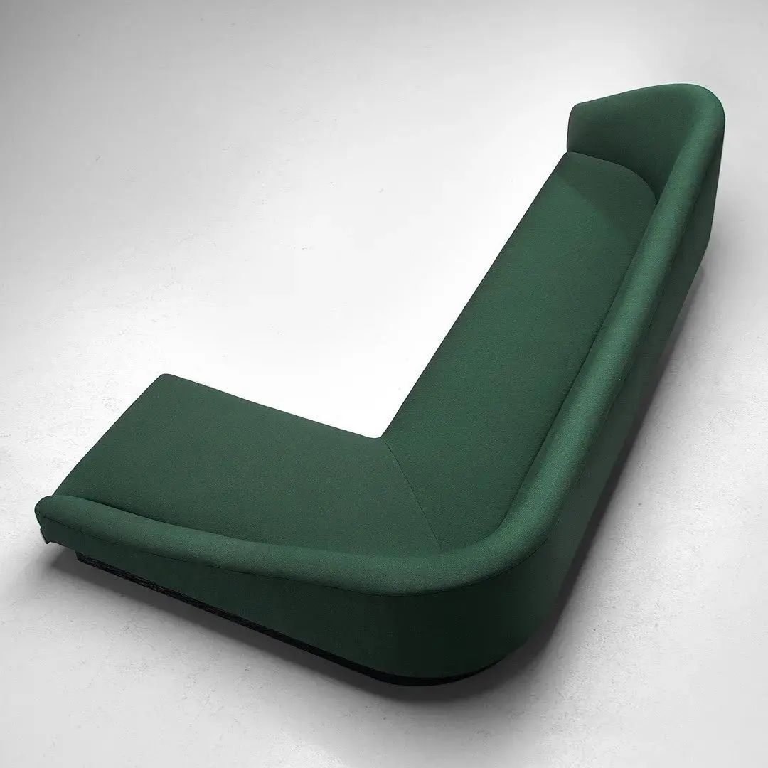 A uniquely designed green chaise lounge