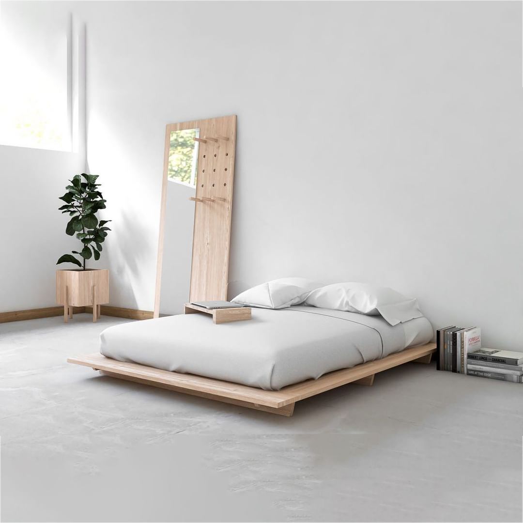 A minimalist bedroom setup with a platform bed