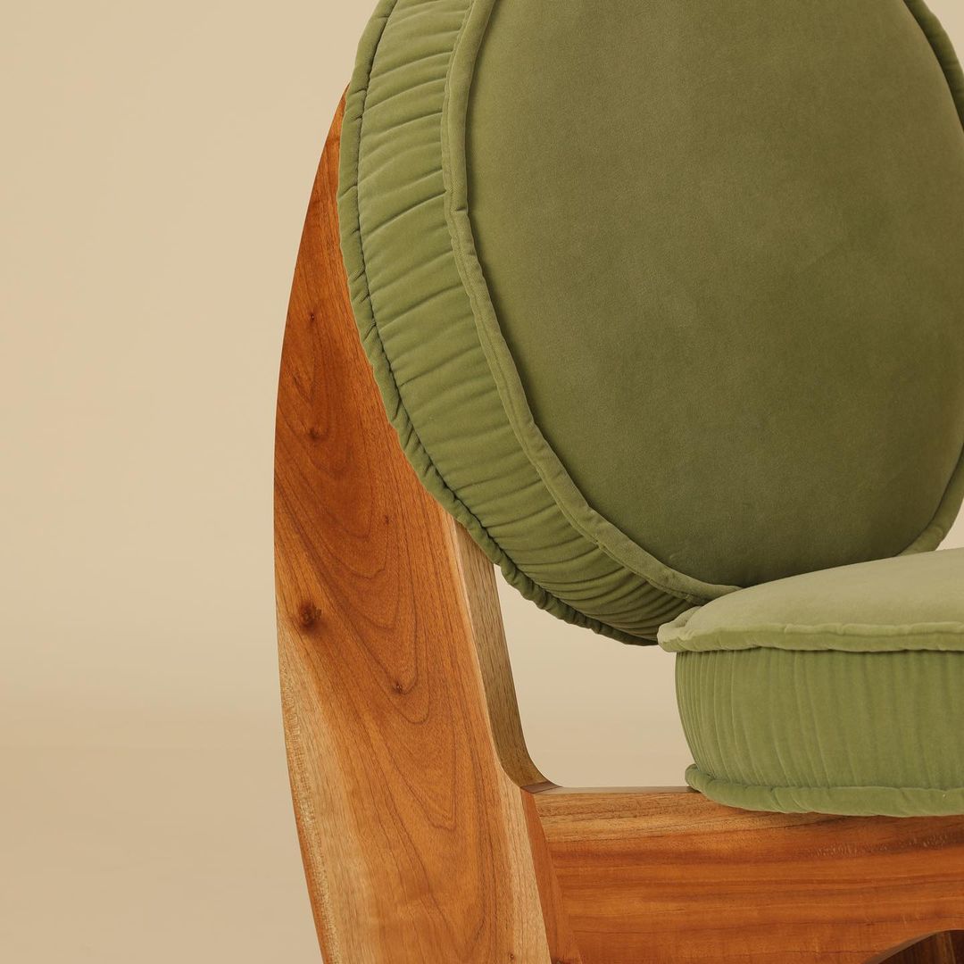 A minimalist chair with plush olive green cushions