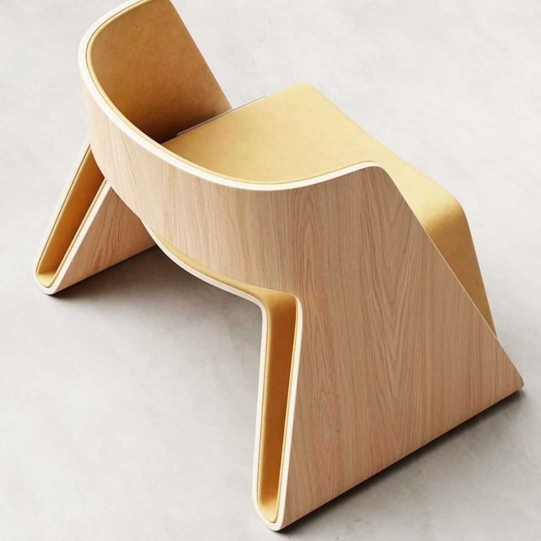 A modern minimalist chair with a smooth wooden finish and curved design