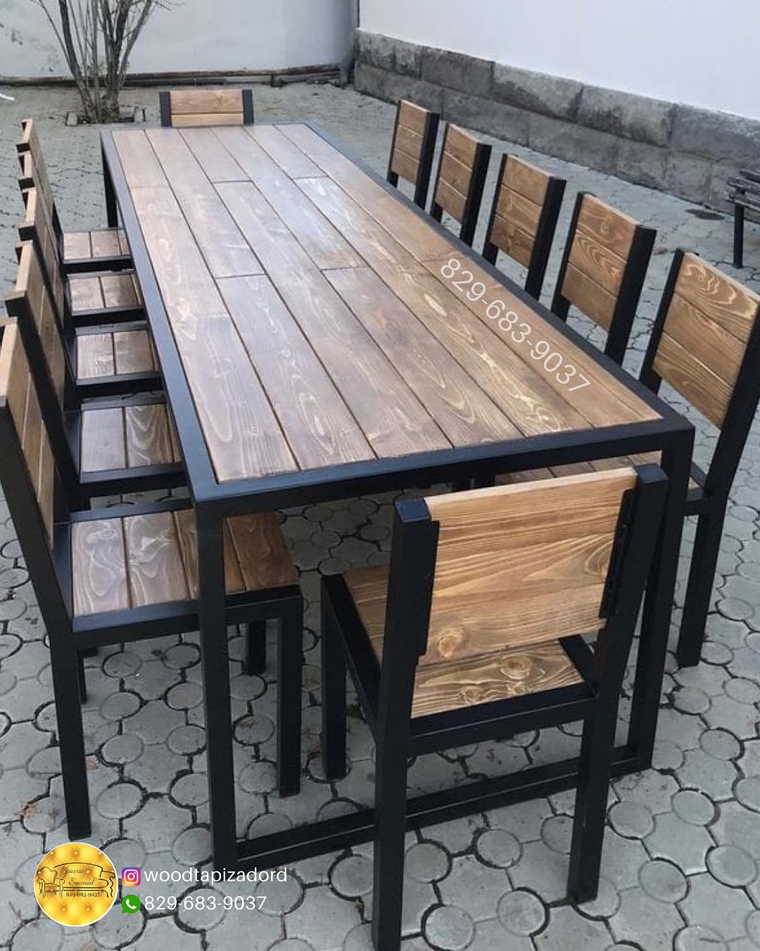 A modern outdoor dining set featuring a sleek black metal frame and richly toned wooden tabletop and seating