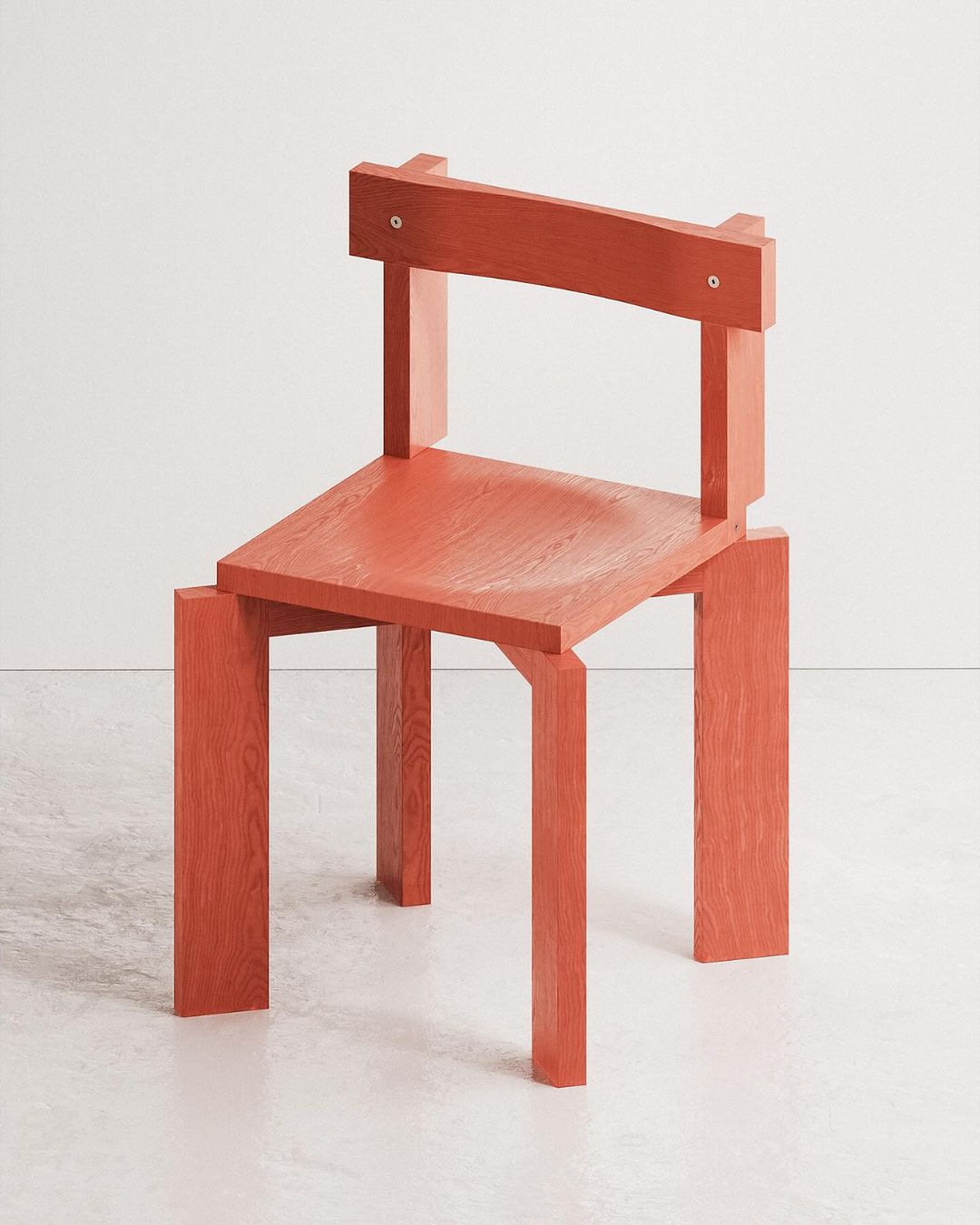 A uniquely designed red chair with a strikingly unconventional backrest