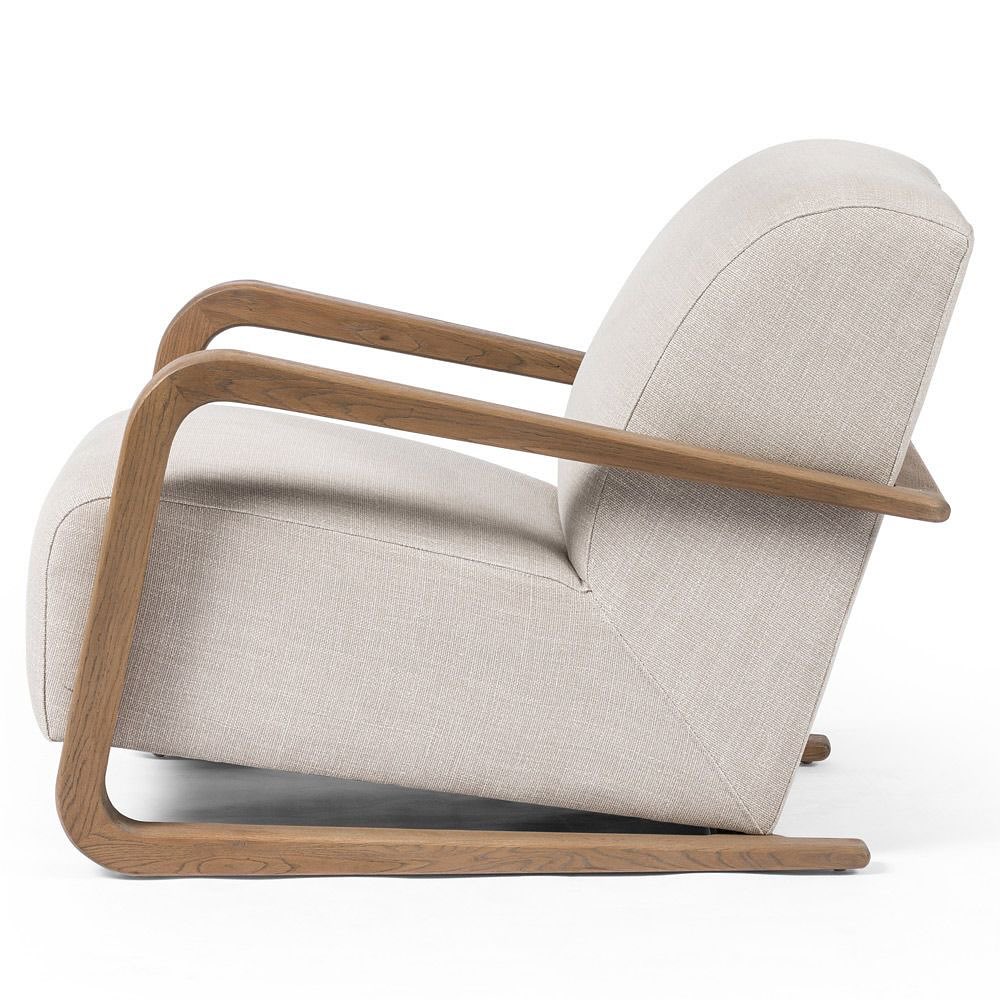 A modern rocking chair with a curved wooden frame and beige upholstered cushions