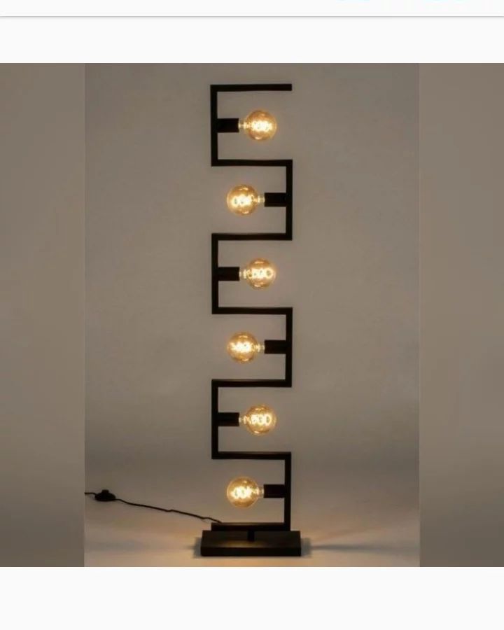 A sleek and modern table lamp featuring a series of bulbs attached to a zigzag metal frame