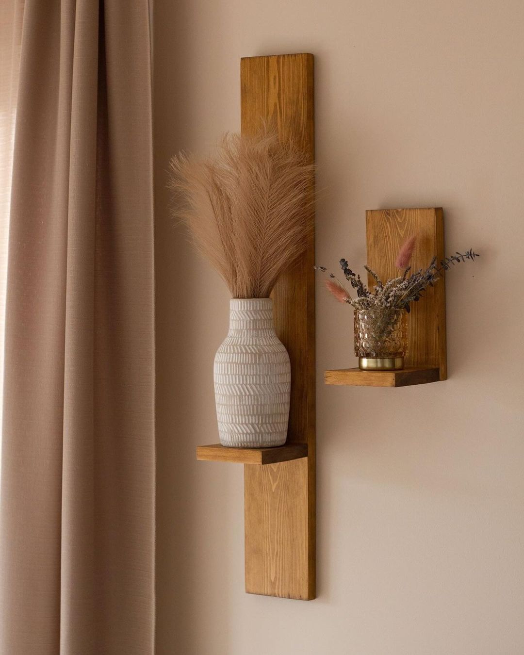 Modern wall-mounted shelves with decorative vases and dried plants