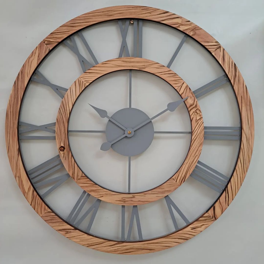 A wall-mounted clock featuring a blend of wood and metal elements