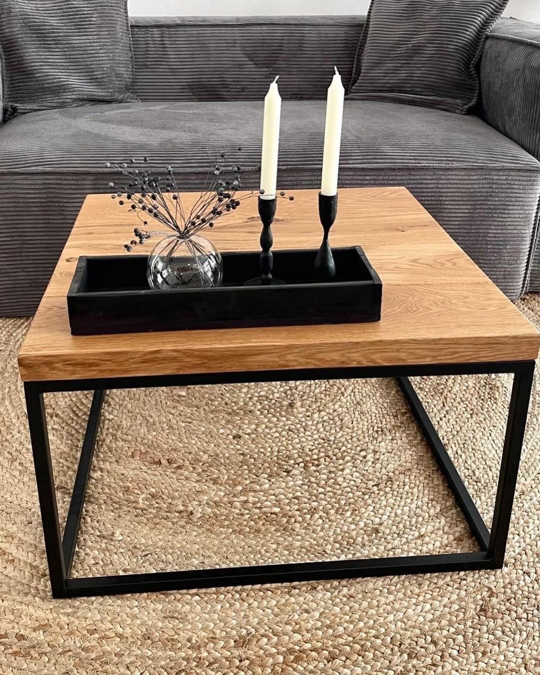 A chic modern living room featuring a wood and metal frame coffee table