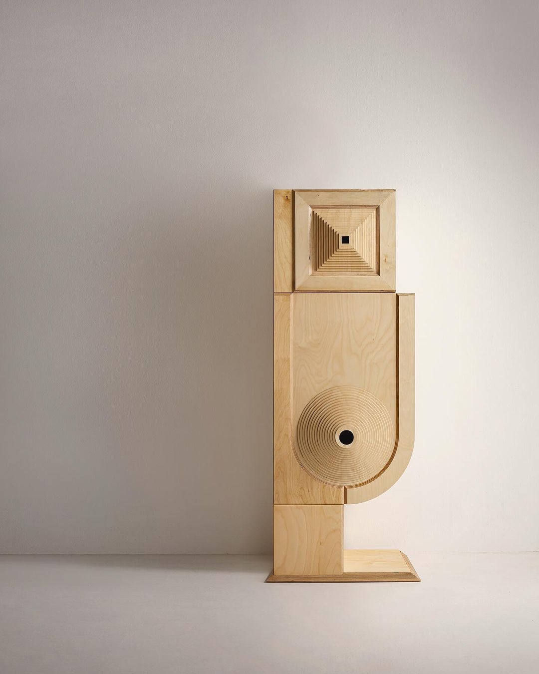 A modern wooden acoustic speaker with geometric design