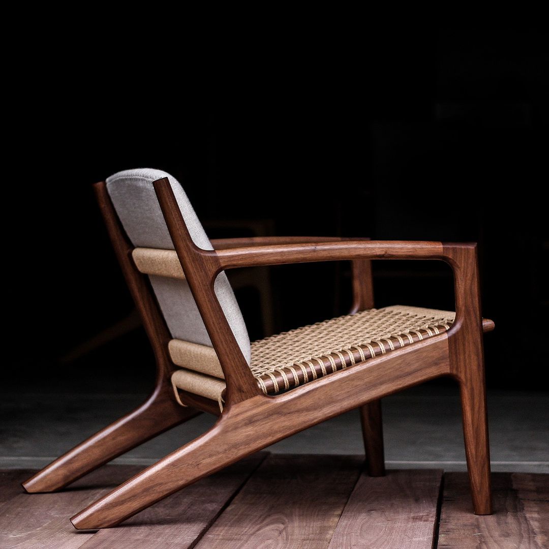 A finely crafted wooden armchair with woven seat