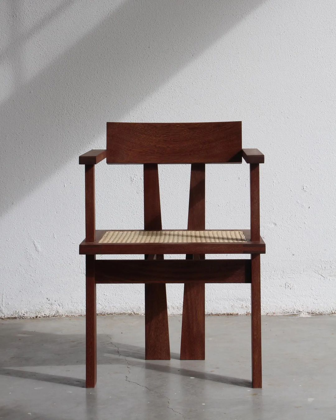 A well-crafted chair with dark wooden frame and woven seat