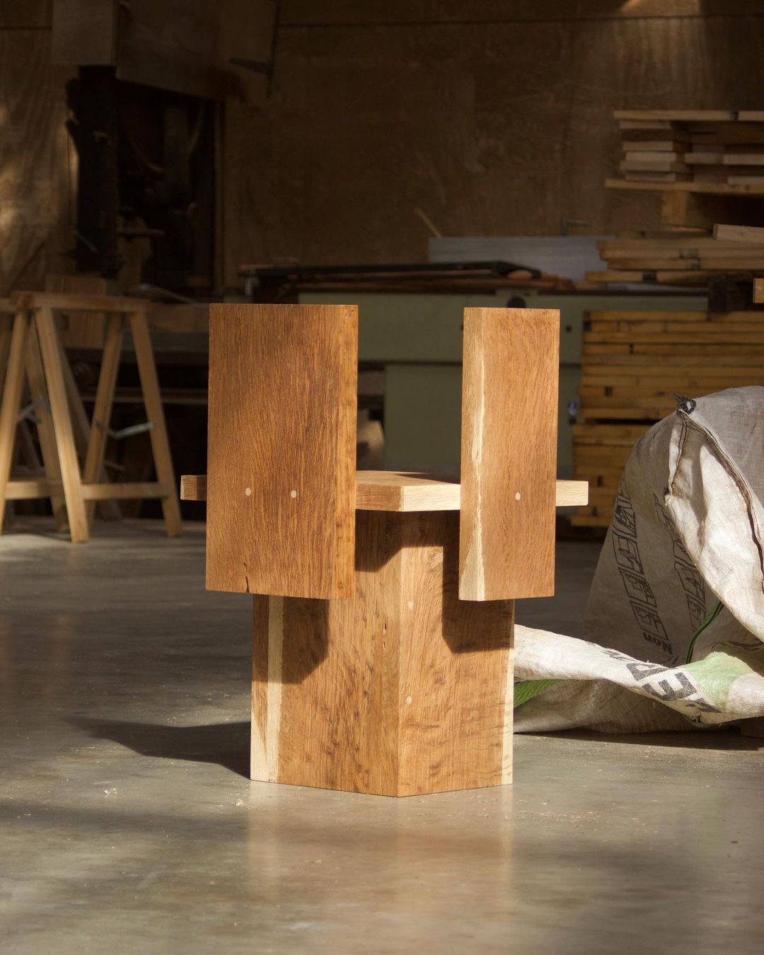 A minimalist wooden chair with a unique geometric design.