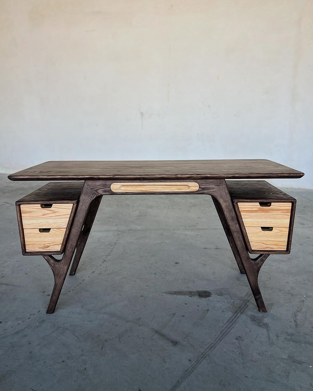 A uniquely designed wooden desk with integrated drawers