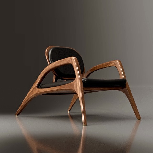 A uniquely designed wooden chair with curvilinear forms and a leather cushion.