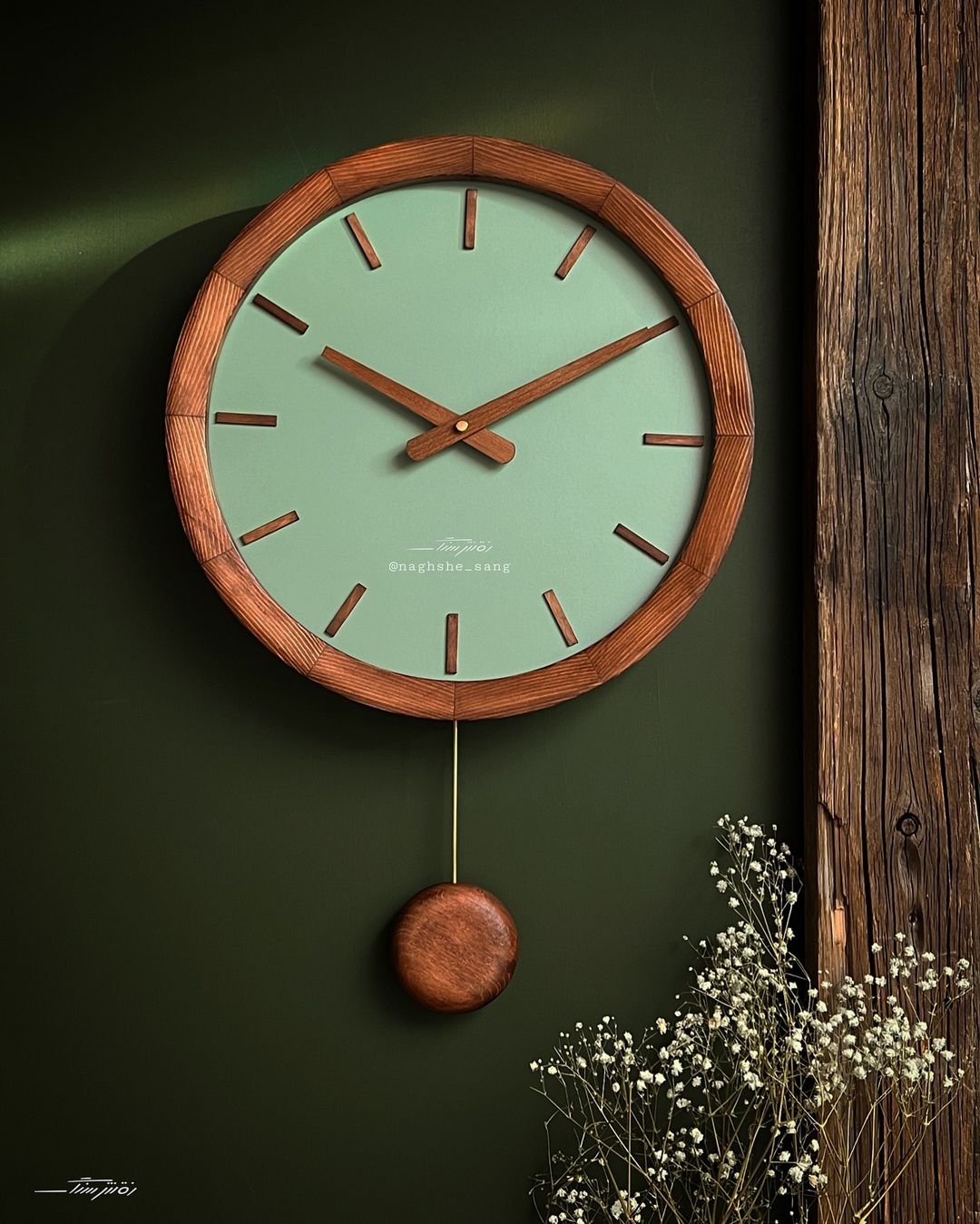 Stylish wooden wall clock with a mint-green face and pendulum