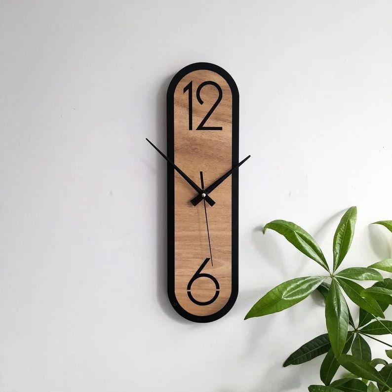 A modern wooden wall clock with black accents and minimalist design