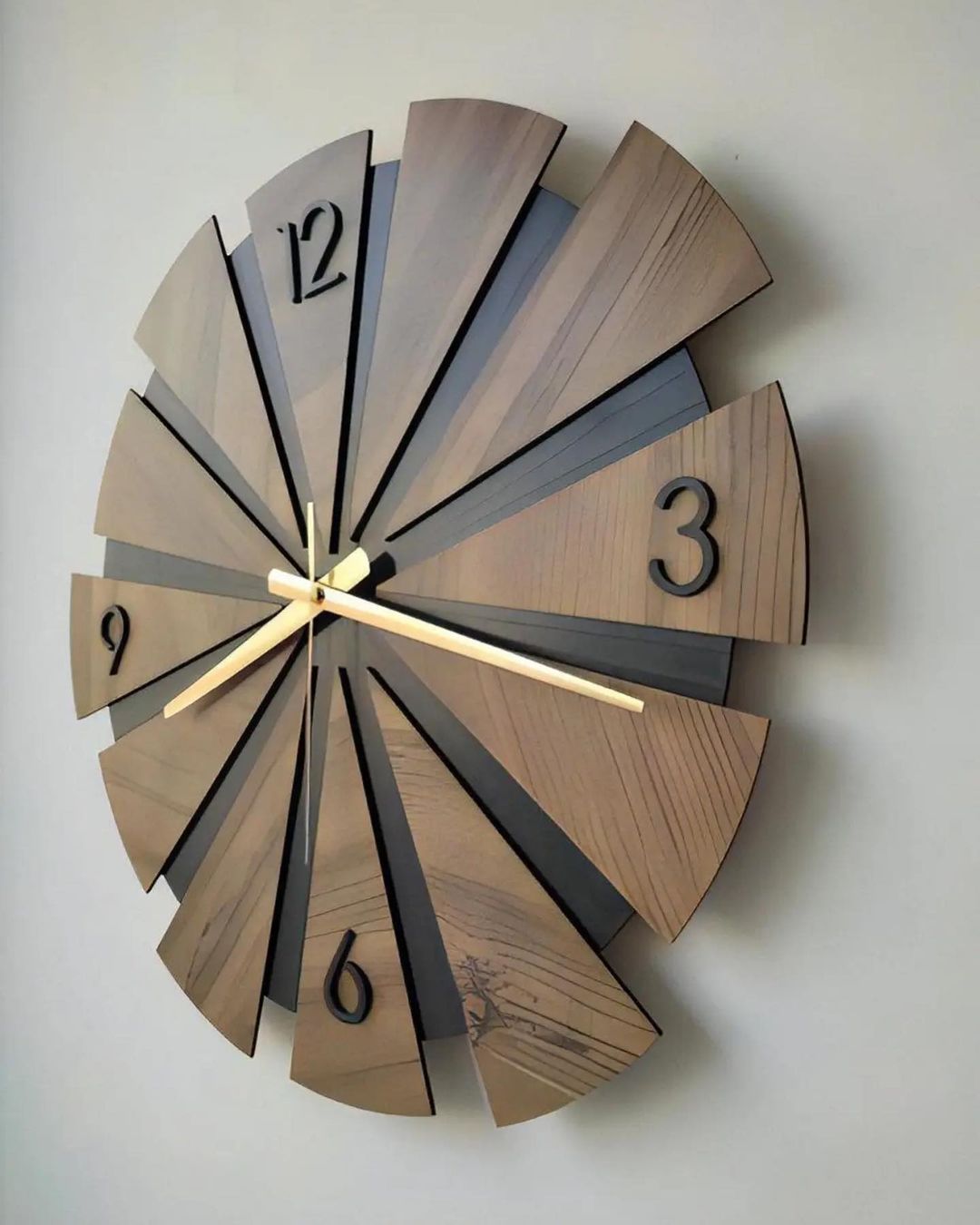 A modern wooden wall clock with segments displaying hours in an exploded view