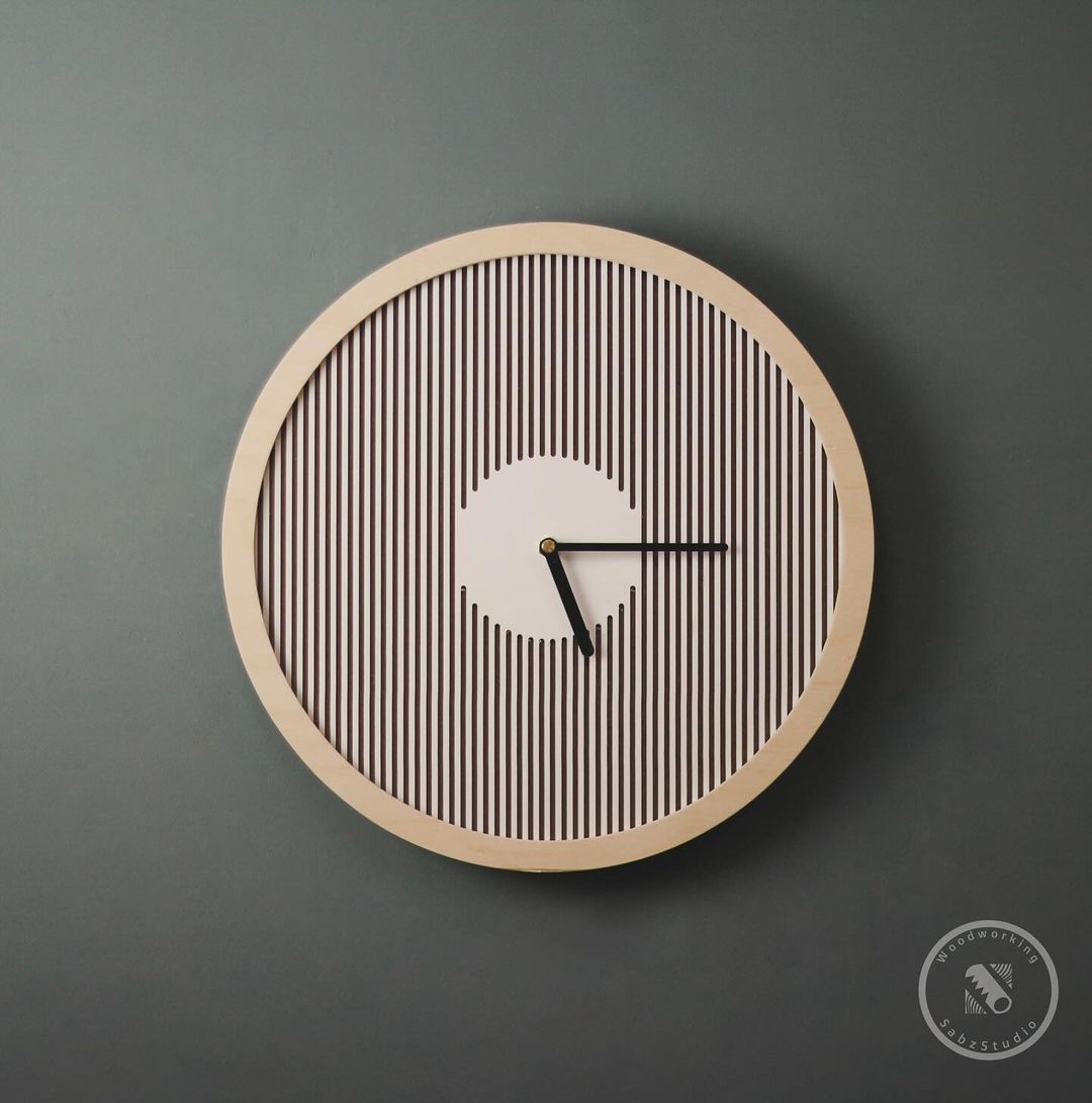 A minimalist wooden wall clock with black hands on a grey background