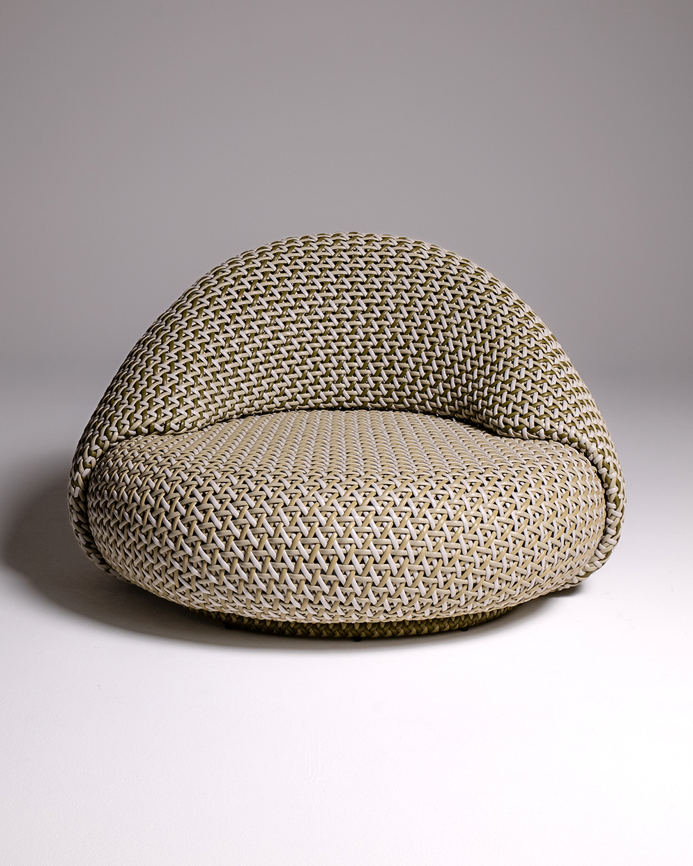 A modern designer chair with intricate herringbone weaving