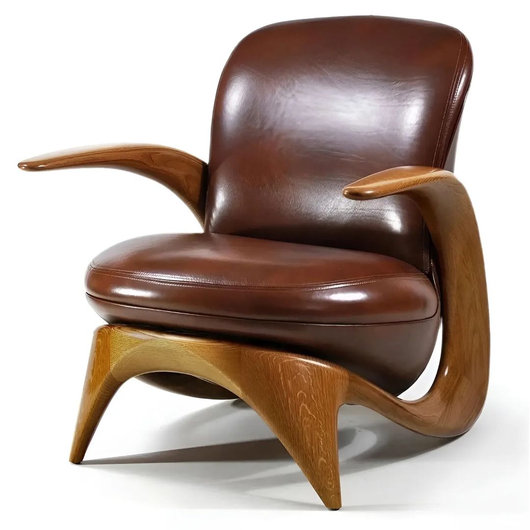 A modernist-style lounge chair with a sleek curved wooden frame and plush brown leather upholstery