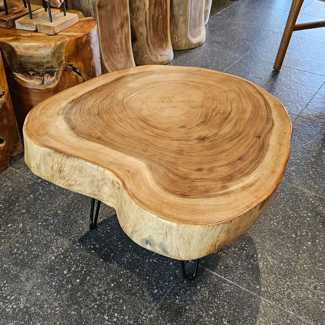 A natural edge wood coffee table with stylish metal legs