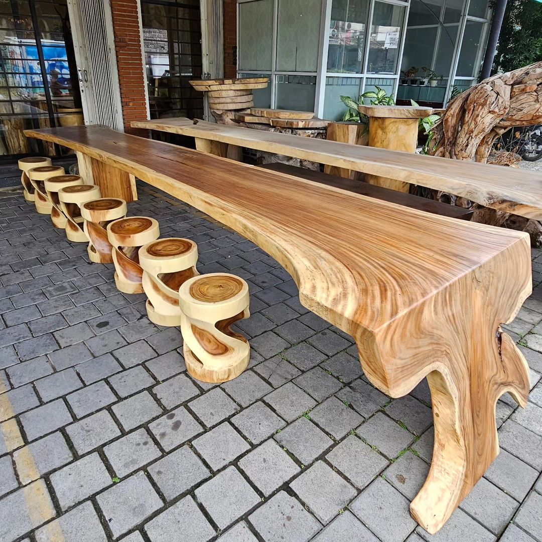 A beautifully crafted natural wood table with matching round stools