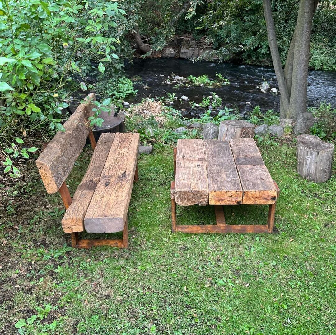 A rustic outdoor wooden picnic table and bench setting